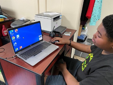 Teen using his laptop