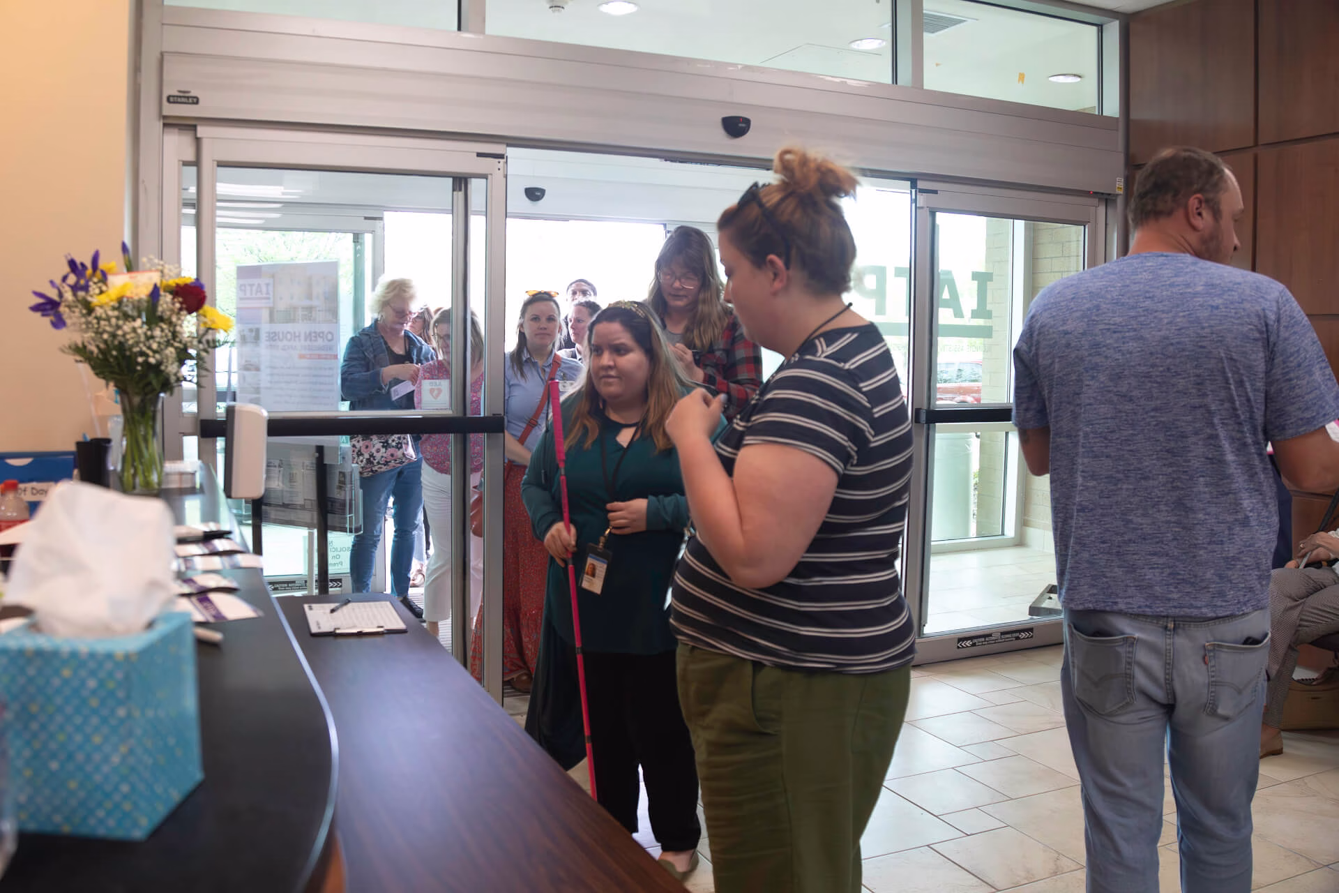 Line of visitors sign in to visit the 2023 IATP Open House.
