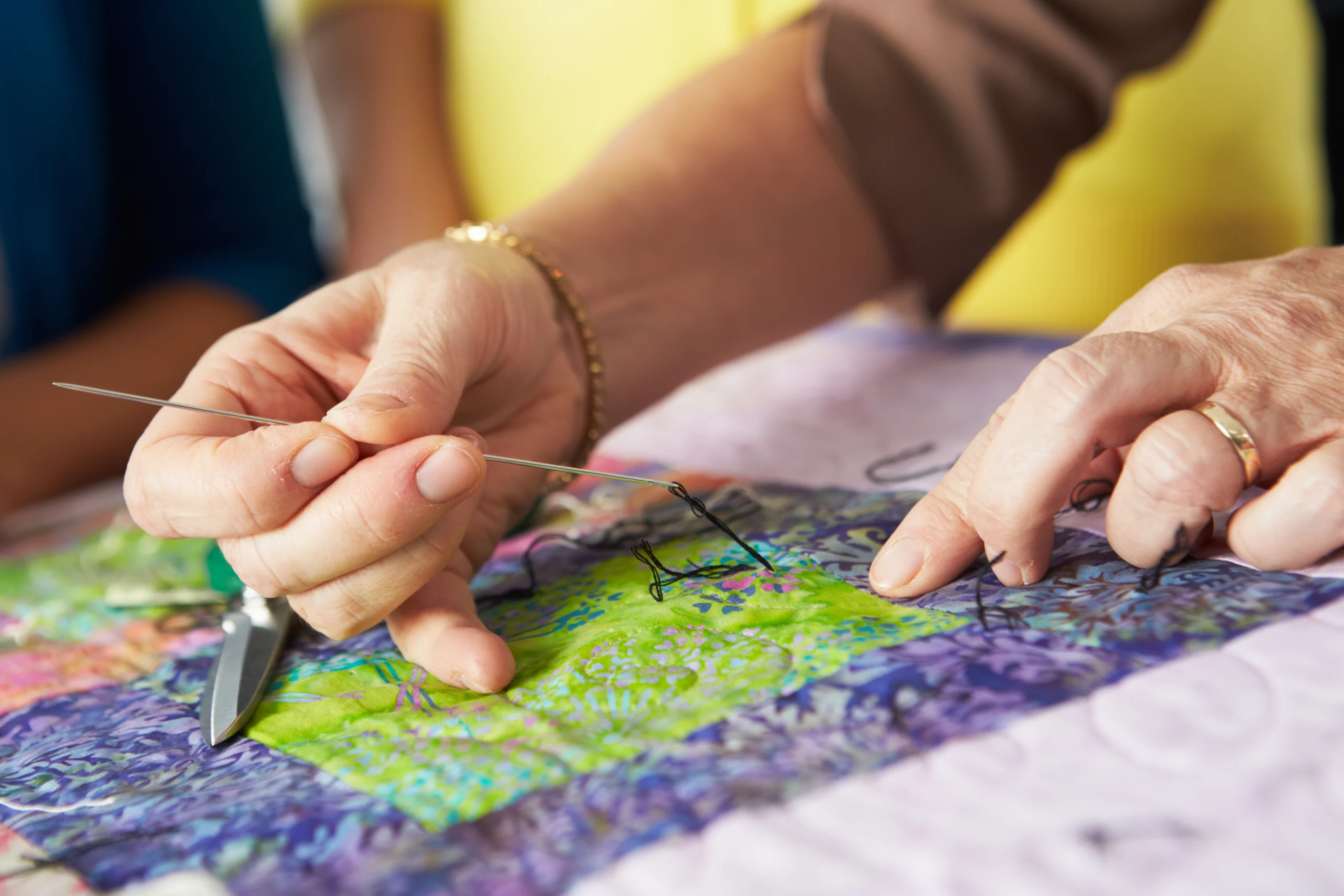 Closeup of a woman's hands quilting