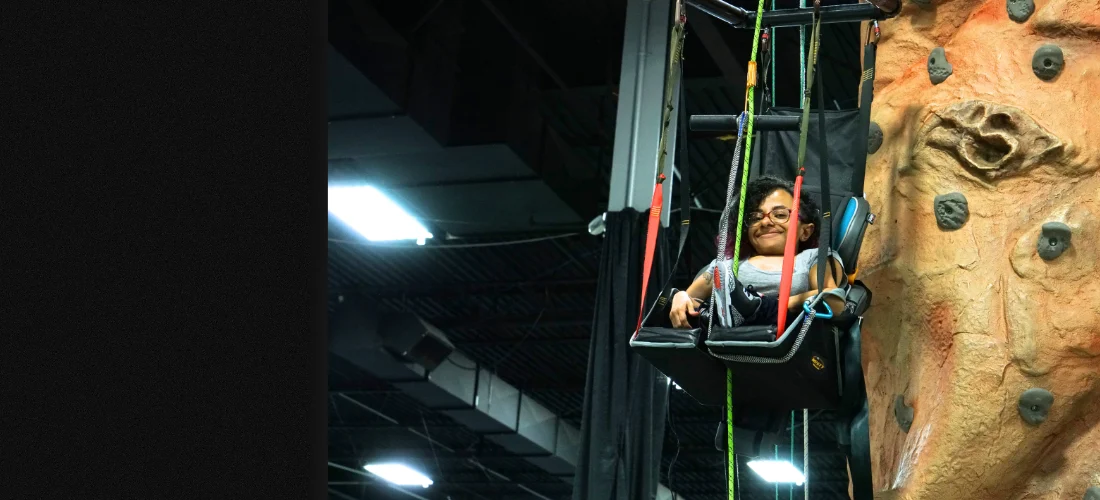 woman in a climbing chair at the abilities expo