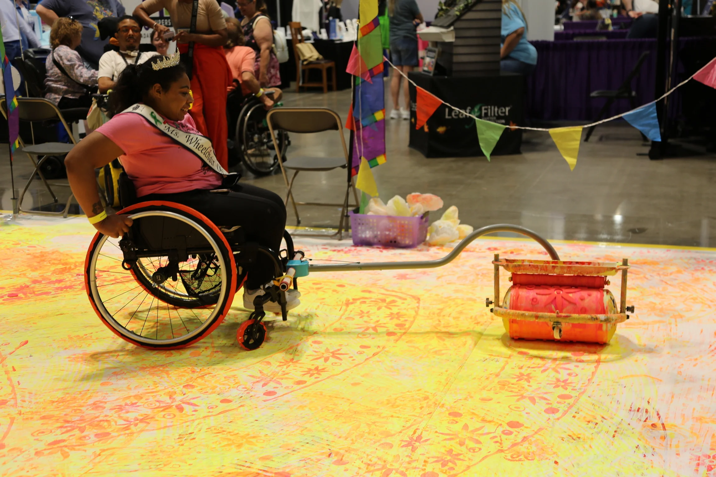 Woman in a wheelchair using a rolling pattern stamper