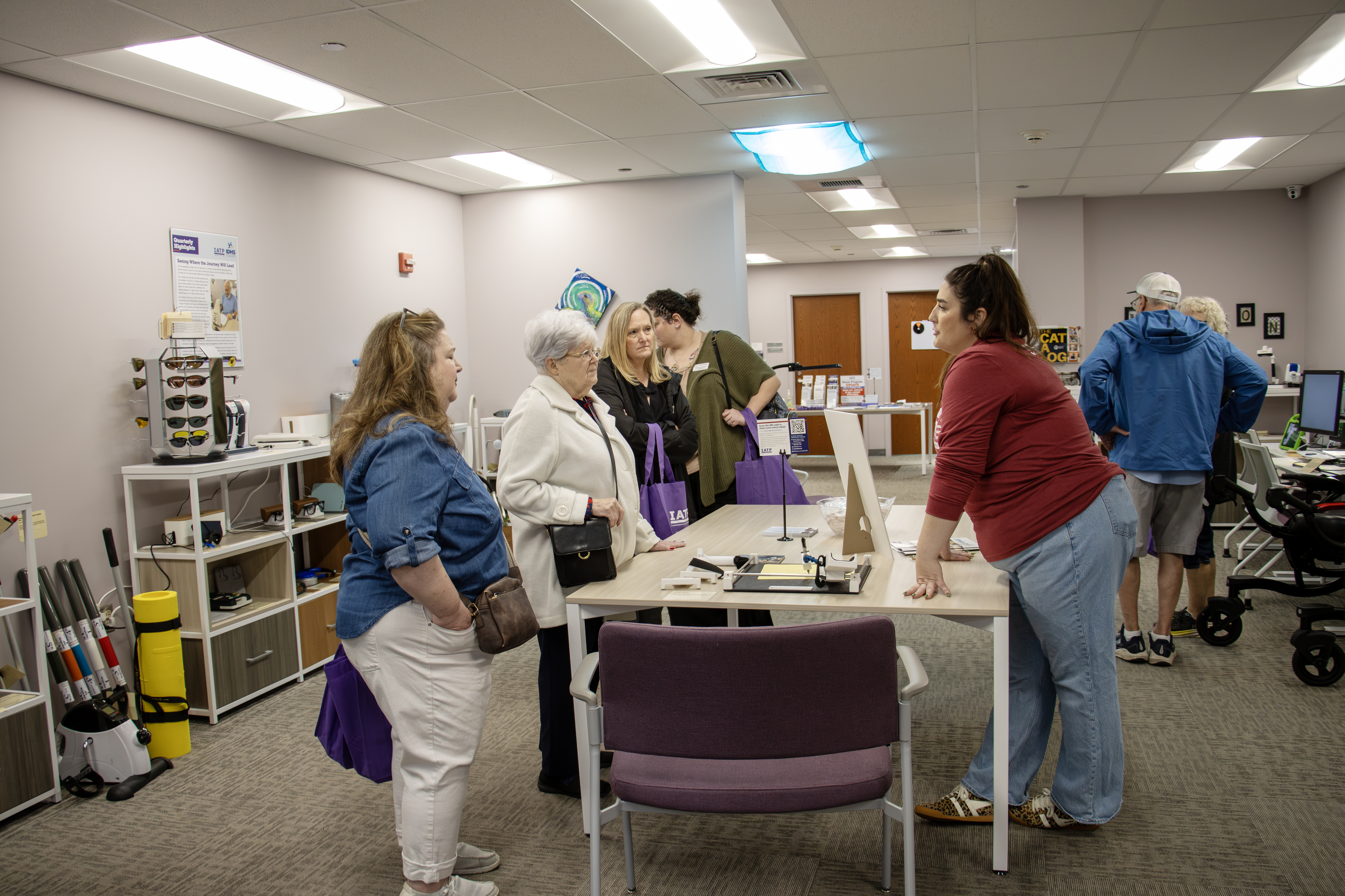 People gather around equipment and displays in the IATP demo center